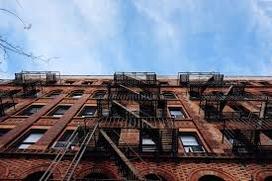 Picture of New York City Apartment building. Looking up from the front of building.